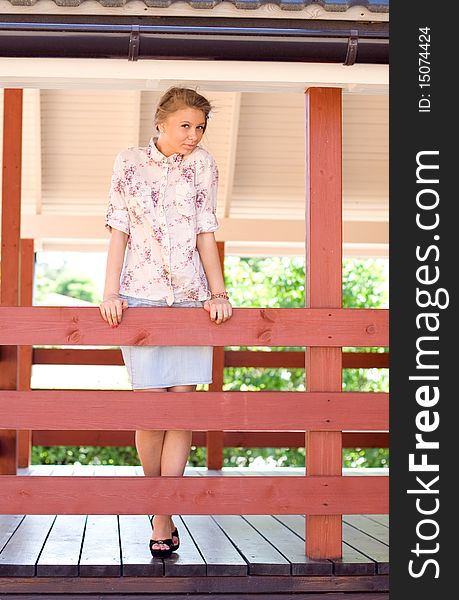 Girl standing on a veranda. Girl standing on a veranda