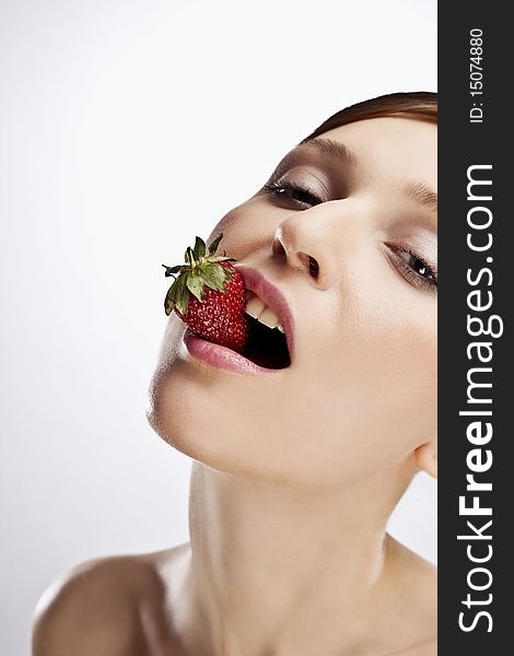 Portrait of woman with strawberry