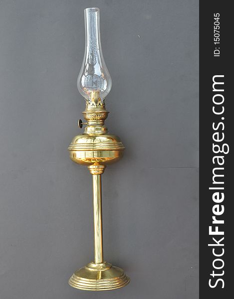 This a old brass lantern which was possibly used indoors. It has a round base filled with sand to give the base weight. The round section in the middle is where you add the fuel or paraffin. The top has a small unique glass filling to protect from the flame.