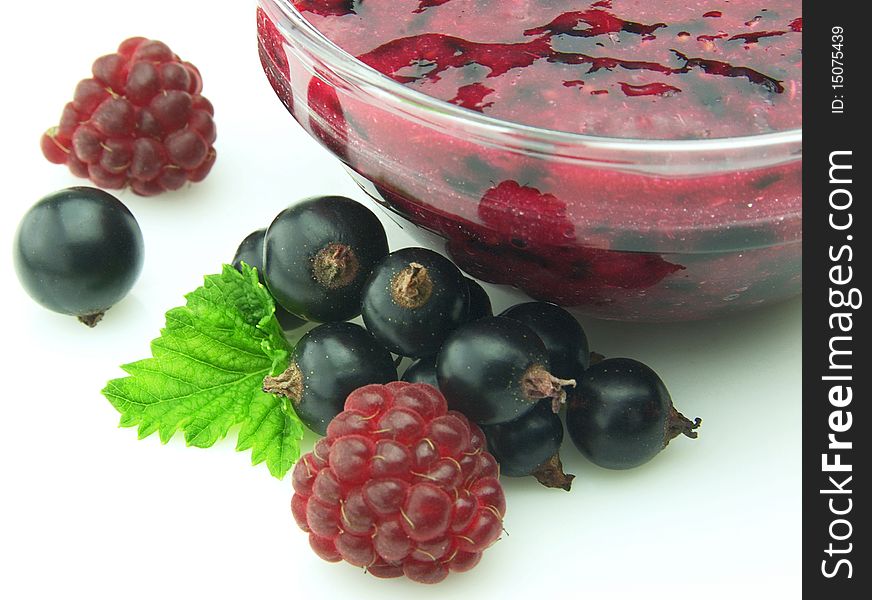 Jam with berries of black currant and raspberry close up