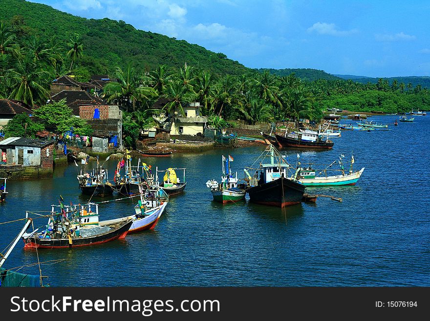 A beautiful waterfront scene in a rural India with lot of traditional cruise boats used for fishing activity.
