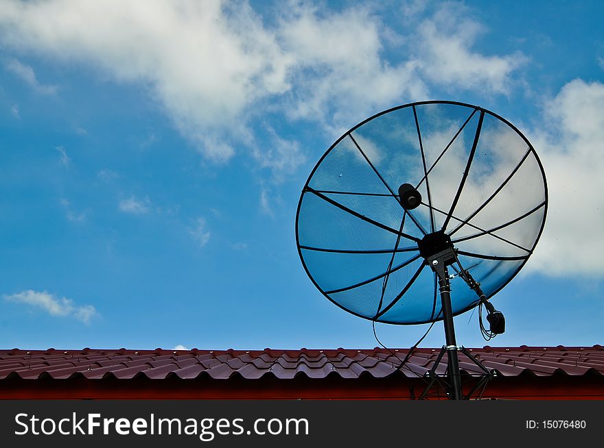 Satellite dish on roof with blue sky