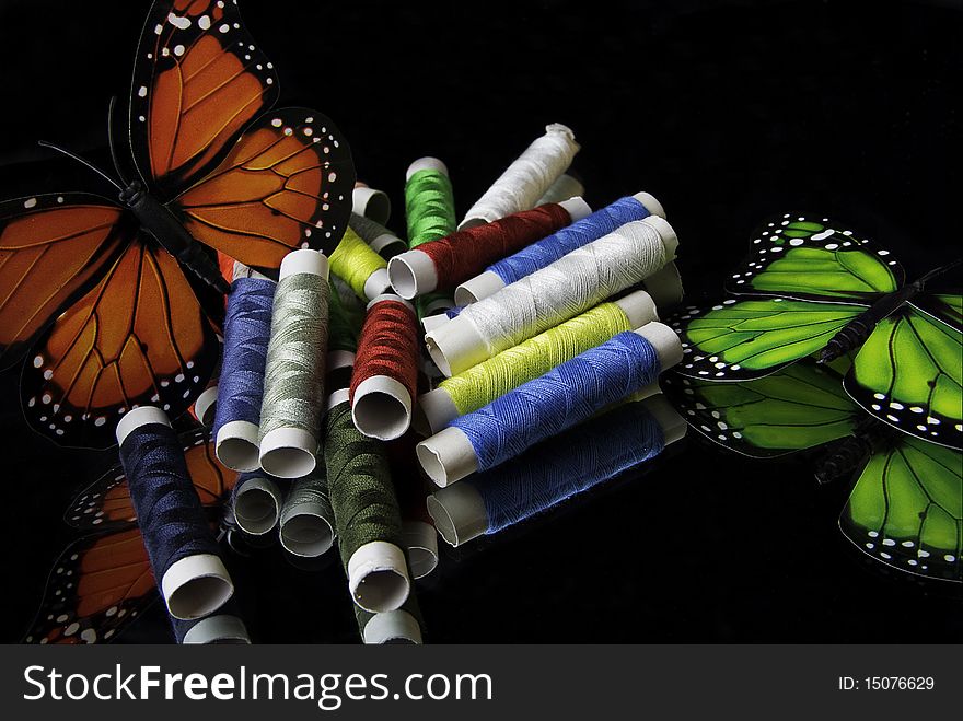 Colorful reels of thread and butterfly