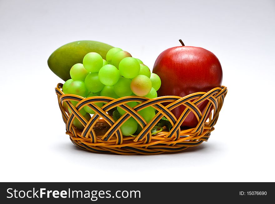 Basket with fruits on white background. Basket with fruits on white background