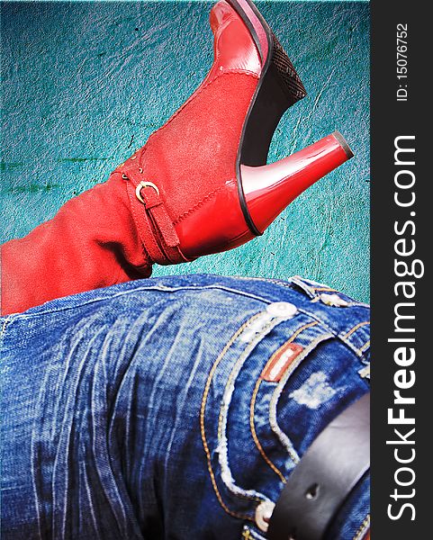 Red women boot on blue background. Red women boot on blue background
