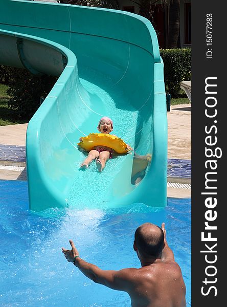 Father catches child on water slide
