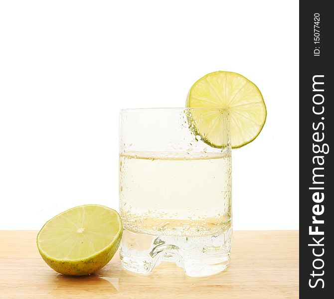 Lime juice with slices of fruit on a wooden board