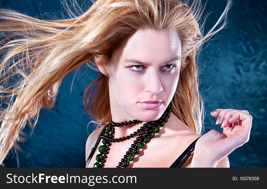 Beautiful  lovely woman with necklace  posing, studio shot