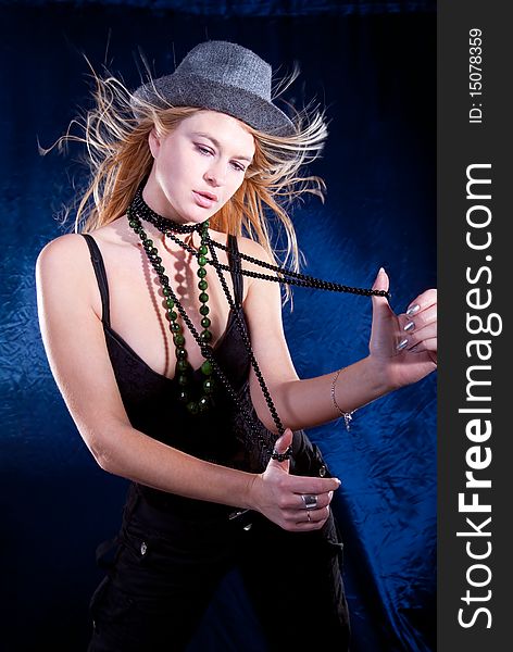 Beautiful lovely woman with necklace and hat posing, studio shot. Beautiful lovely woman with necklace and hat posing, studio shot