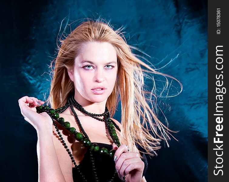 Beautiful  lovely woman with necklace  posing, studio shot