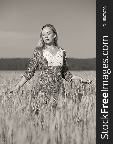 Young beauty girl in the wheat field