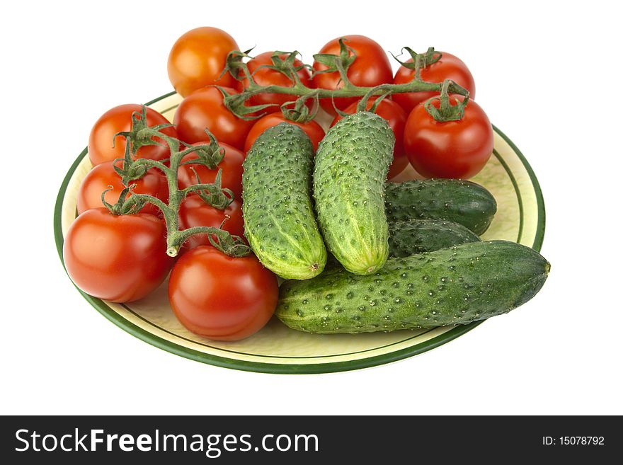 Fresh raw tomatoes and cucumbers on a plate. Fresh raw tomatoes and cucumbers on a plate
