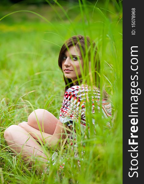 Brunette  girl in dress in the park