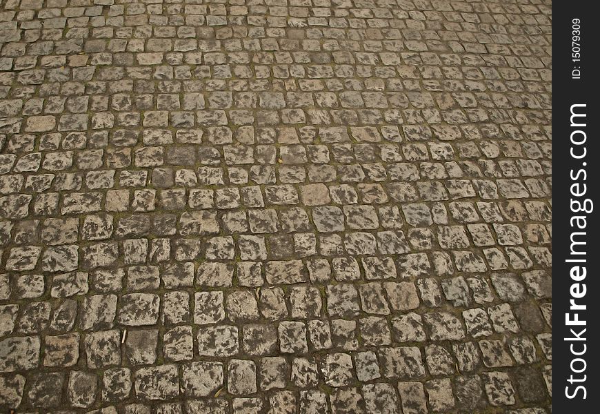 Stone as raw material for the construction of roads, streets, sidewalks, and background and texture