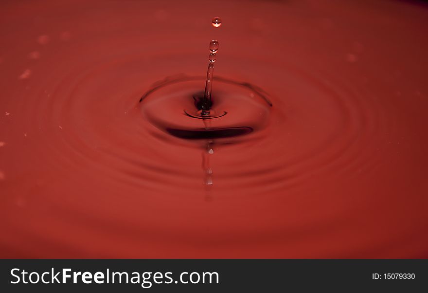 Water droplets cptured while descending on to the still water surface. Water droplets cptured while descending on to the still water surface