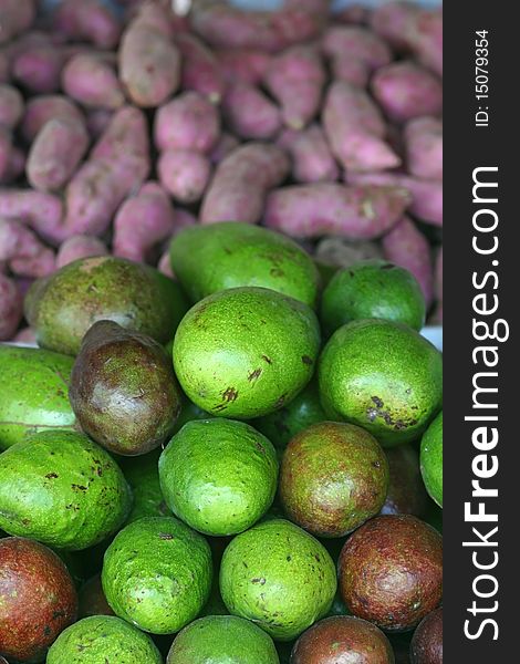 Avocados and Taro or purple yam in a fruit stand in the Philippines. Avocados and Taro or purple yam in a fruit stand in the Philippines