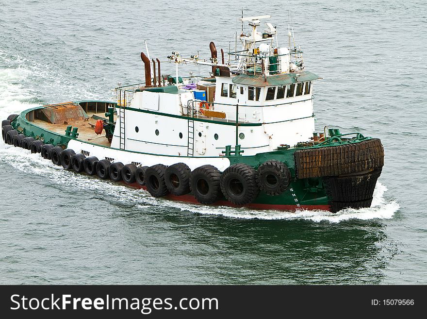 Tug boat traveling through the water. Tug boat traveling through the water