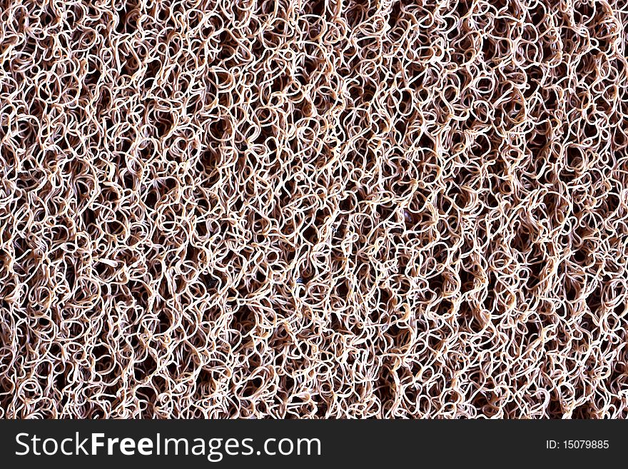 A close-up view of an Brown plastic dust doormat background