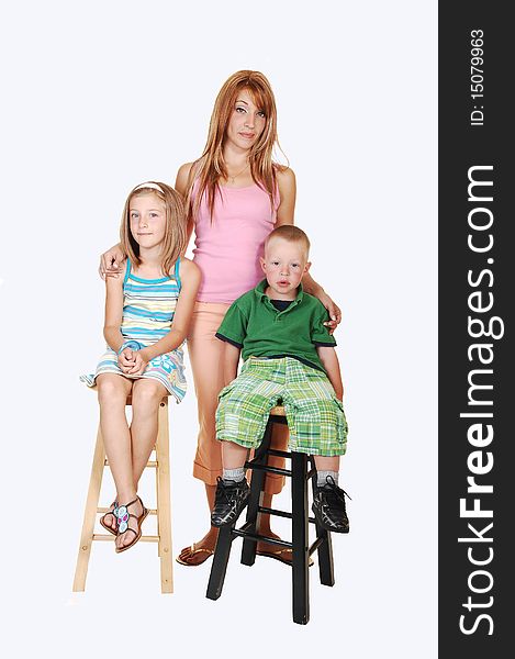 An young family, a mother with her two kids, an seven year girl and a
three year boy sitting on chairs in the studio for white background. An young family, a mother with her two kids, an seven year girl and a
three year boy sitting on chairs in the studio for white background.