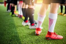 Boy Soccer Players Are Put Multi Color Sport Shoes And Standing On Green Artificial Turf With Coach Stock Photos