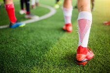 Soccer Player Jogging On Green Artificial Turf And Stretching Their Feet. Warming Up The Body And Foot Royalty Free Stock Photo