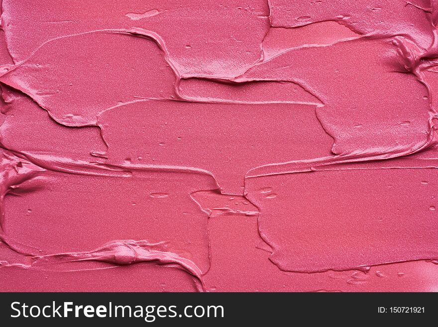 Gently pink strokes and texture of lip gloss or acrylic paint isolated on white background