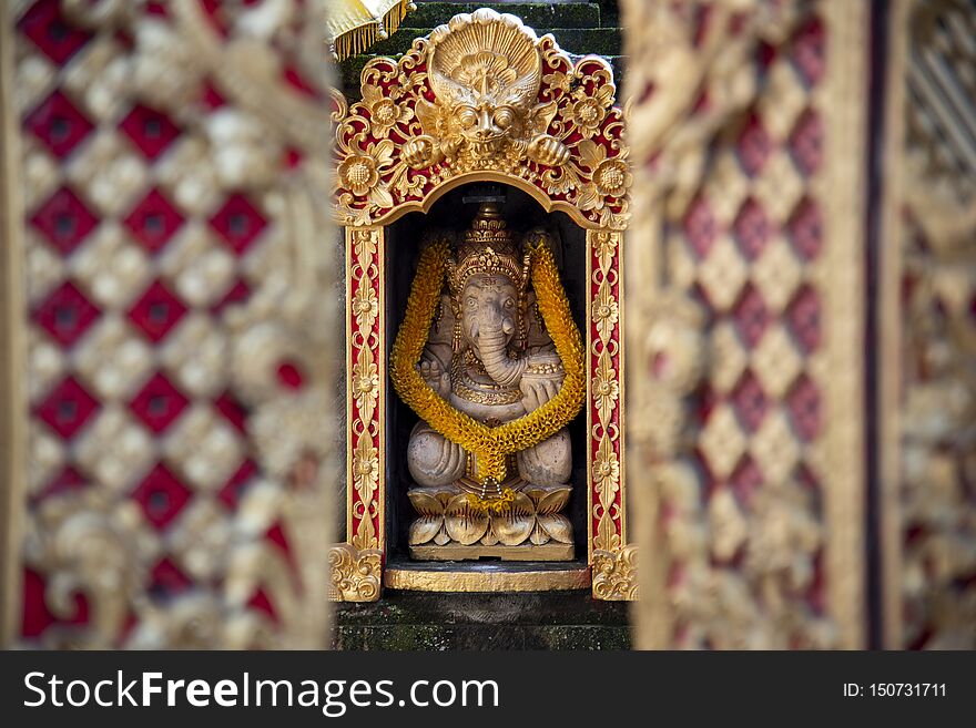 Traditional Bali Ganesha of Hindu god sculpture, is one of the best-known and most worshipped deities in the Hindu pantheon.  Bali island, Indonesia, art, statue, stone, religious, travel, culture, asia, religion, temple, balinese, old, hinduism, indonesian, closeup, flowers, decoration, symbol, architecture, detail, ancient, spirituality, offering, outdoor, asian, tourism, history, oriental, beautiful, ganapati, vinayaka, decorated, design, binayak, pillaiyar, background