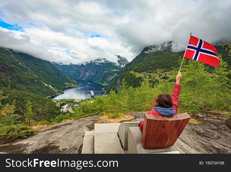 Tourist Over Geiranger Fjord Holds Norwegian Flag