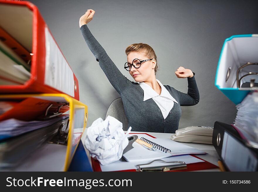 Boredom and fatigue concept. Young emotional expressive woman in office. Bored tired businesswoman yawning stretching at work. Boredom and fatigue concept. Young emotional expressive woman in office. Bored tired businesswoman yawning stretching at work