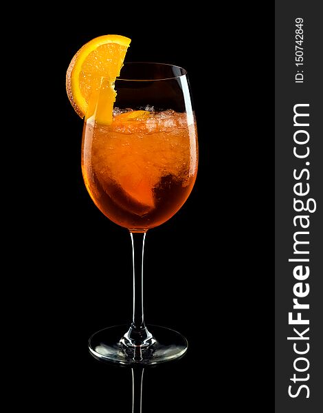 Aperol syringe in glass with orange, summer cocktail over black background. Aperol syringe in glass with orange, summer cocktail over black background