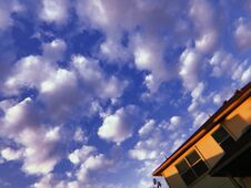 Puffy White Clouds On A Blue Sky In Suburbia Stock Photo