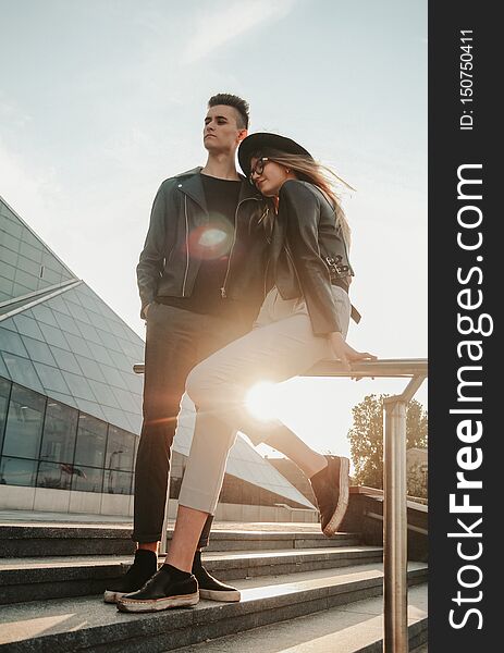 Attractive young couple standing on stairs at building