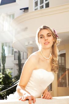 Young Bride Leaning Over Railing Royalty Free Stock Photos