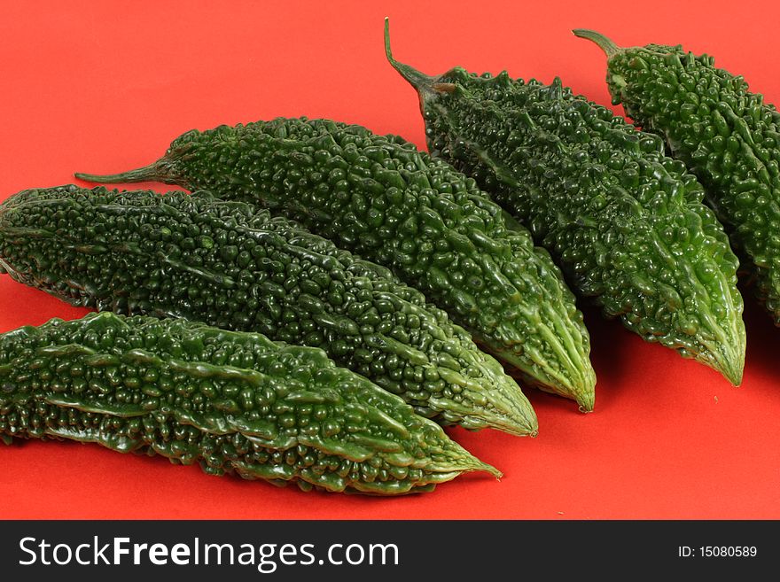 Bitter melon on red background