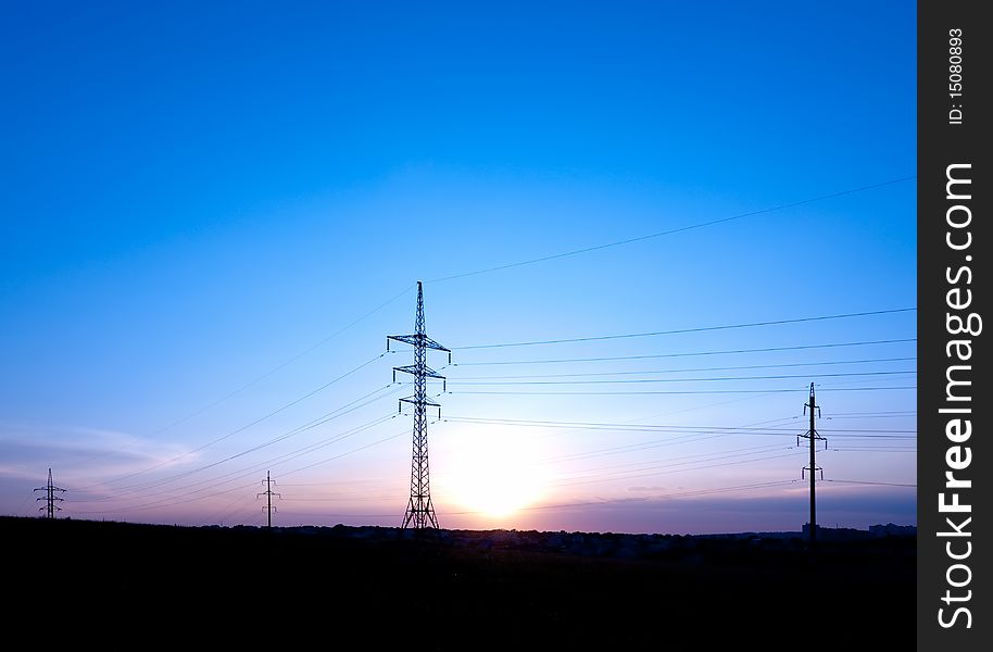 Powerlines. Sunset with silhouettes of pillar