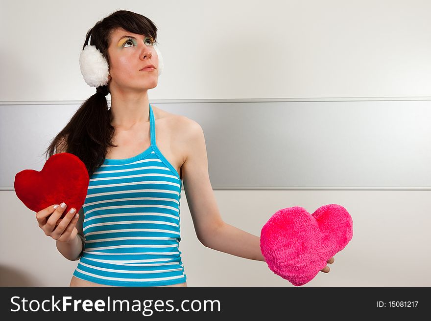 Lovely girl holding two plush hearts. Lovely girl holding two plush hearts.