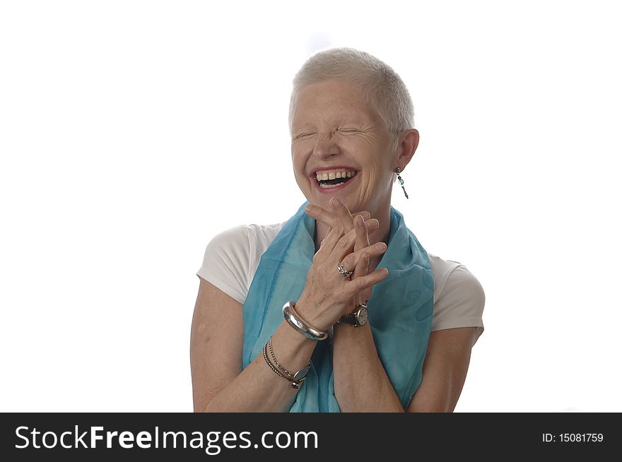 Senior woman laughs spontaneously in front of the white background. Senior woman laughs spontaneously in front of the white background.