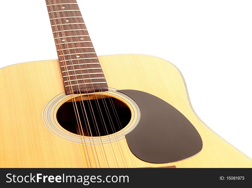 A 12 string acoustic guitar isolated on a white background. A 12 string acoustic guitar isolated on a white background