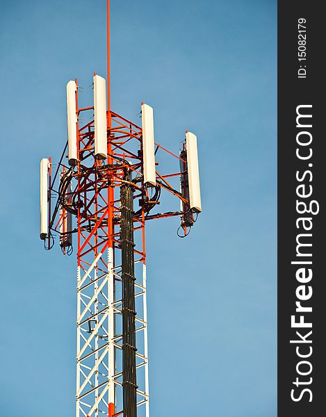 Communication tower against blue sky.