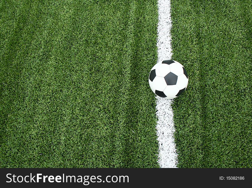 The football on soccer field with line