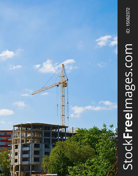 Photos of high-rise construction cranes and unfinished house against the blue sky with clouds.