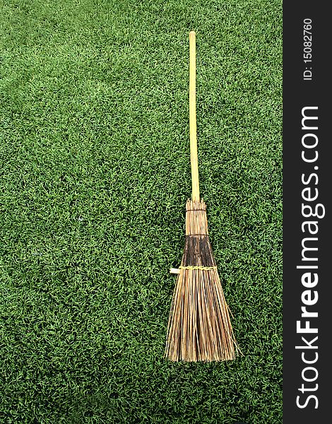 Broom on green grass