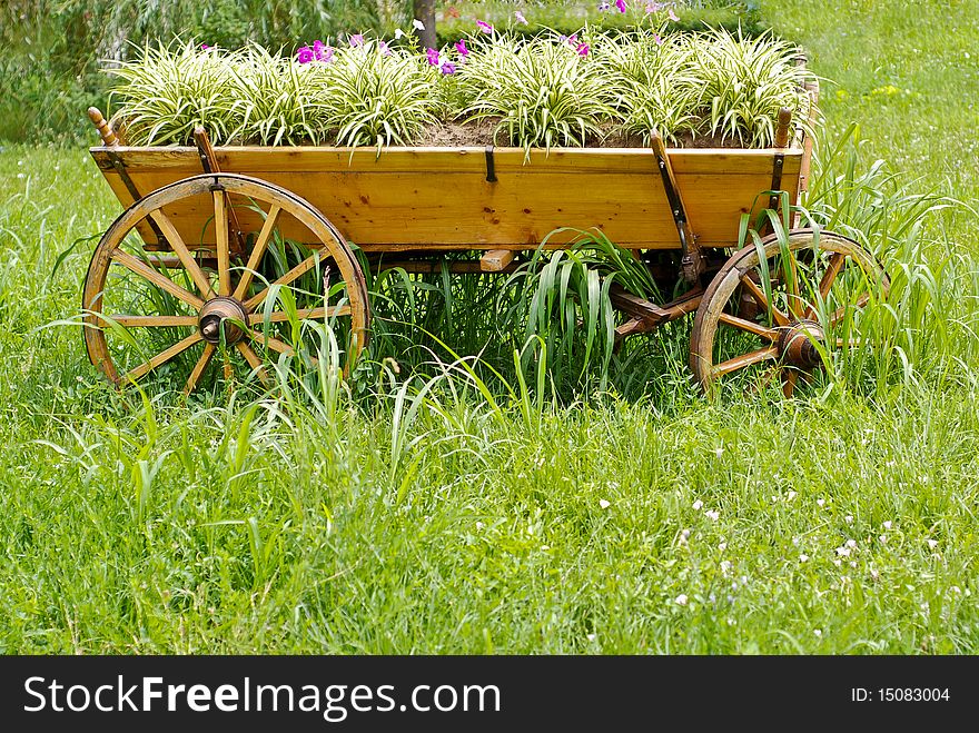 A wooden carriage filled with flowers. A wooden carriage filled with flowers.