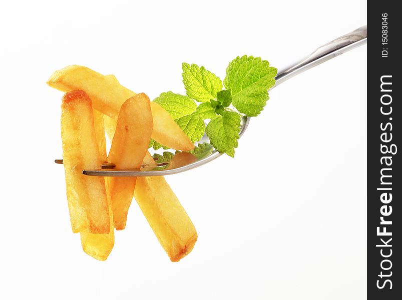 French fries on a fork - closeup