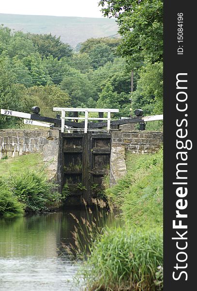 A canal lock in summer on the huddesfield narrow canal.