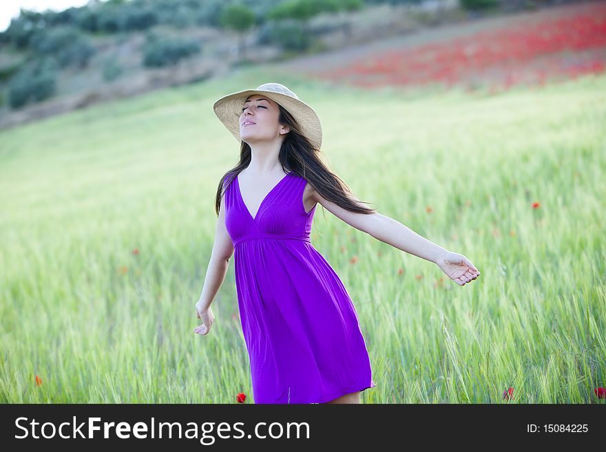 Young beautiful girl feeling freedom on meadow. Young beautiful girl feeling freedom on meadow