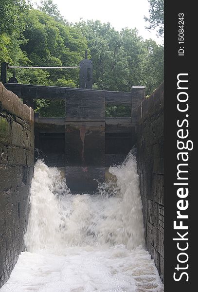 A canal lock filling up in summer on the huddesfield narrow canal.