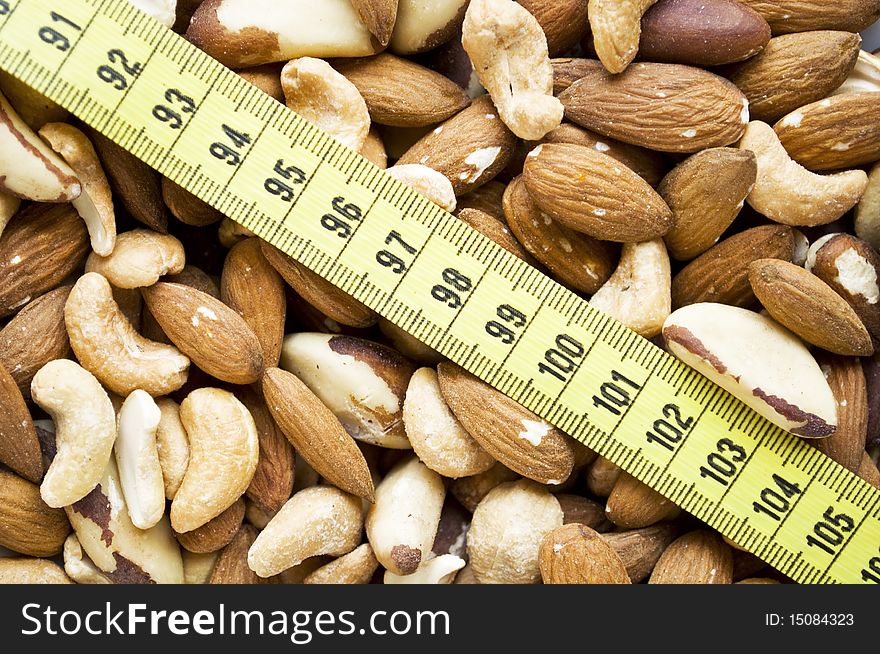 Assorted nuts with measure tape - weight concept -