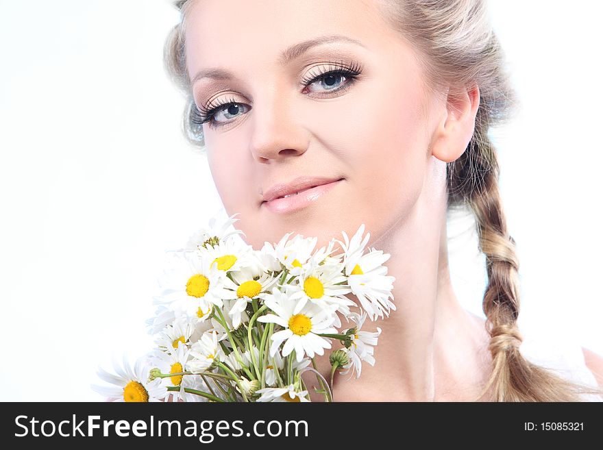 Close-up portrait of a fresh and beautiful woman with camomile.