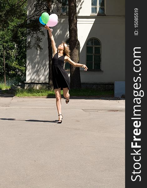 Joyful girl with balloons outdoor